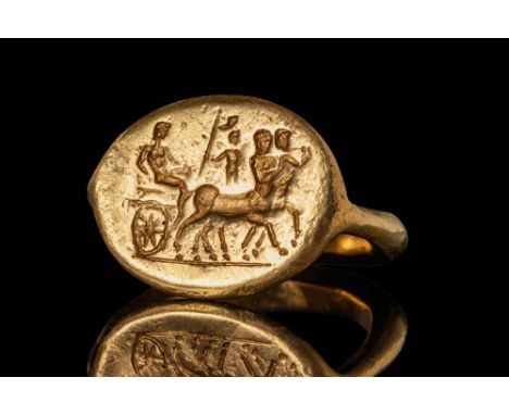 Ca. 400 BC.A gold 21 ct ring with a polygonal section round hoop tapering to the shoulders to form an oval bezel engraved wit