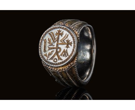 Ca. AD 1200 - 1400.A beautiful silver gilt ring with a round hoop adorned with three ridges composed of lines of pellets, whi