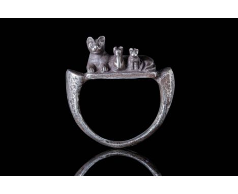 Late Period, Ca. 664 - 332 BC. A silver ring with a semicircular hoop featuring a conical section tapering to the bottom, con