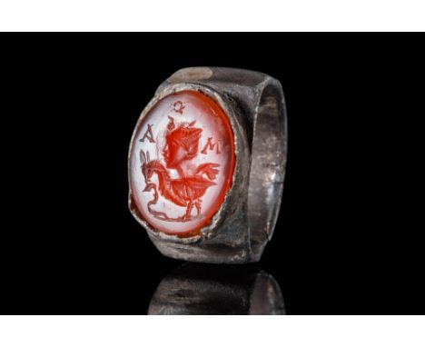 Ca. AD 100 - 300.A stunning silver ring composed of a round hoop with a stepped external surface, set with a carnelian intagl
