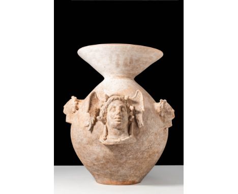 Ca. 400 - 300 BC.A krater from Canosa made of purified clay with a globular body and a funnel-shaped neck. Four heads of deit