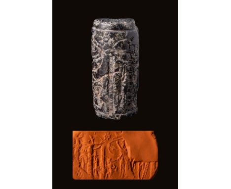 Ca. 850 - 650 BC.A dark brown stone cylinder seal. The scene depicts a town being besieged. The majority of a town's gateway 