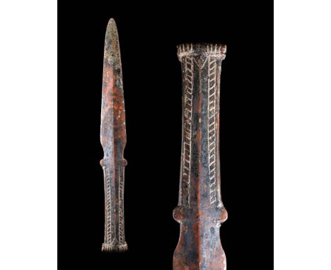 Ca. 1200 - 700 BC.A bronze dagger with decorative geometric motifs on both the handle and the ricasso. This dagger also has a
