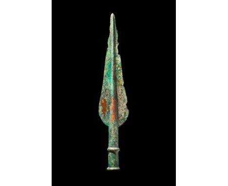 Ca. 1200 - 800 BC.A bronze spearhead with a triangular-shaped blade that tapers towards a point, and with a raised midrib. Th