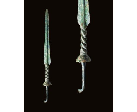 Ca. 1200 - 800 BC.A lengthy, leaf-shaped bronze spear point with angular shoulders, cast as a single piece. A prominent midri