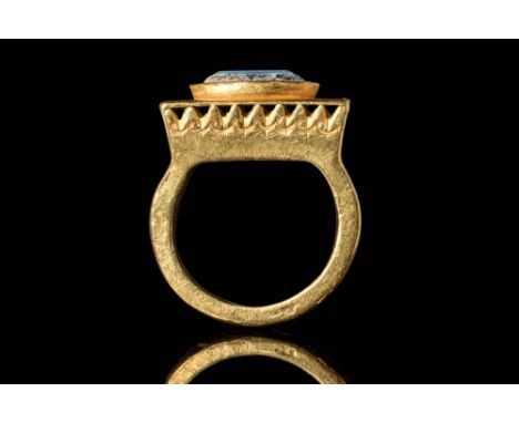 Ca. AD 250 - 450. A gold ring composed of a flat-section round hoop, joined to a prominent rectangular-shaped flat bezel bord
