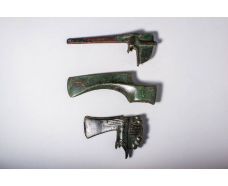 Ca. 2500 - 1500 BC.A collection of three bronze weapons, The first is a pickaxe with a long polygonal point and a small short