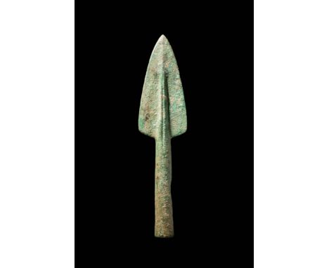 Ca. 1200 - 800 BC.A bronze spearhead with a short triangular-shaped blade that tapers towards a point, and with a raised midr