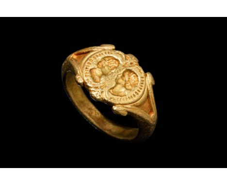 Ca. AD 200 - 400.A gold 22.6 ct ring comprising of a D-section hoop with angled triangular shoulders and scrolled edges. The 
