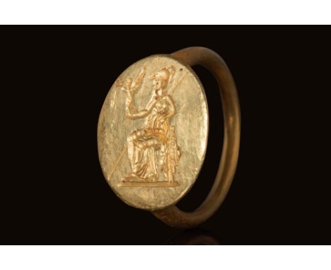 Ca. 400 BC.A gold signet ring with a thin, round-section hoop leading to a large, oval-shaped bezel. The bezel is engraved wi