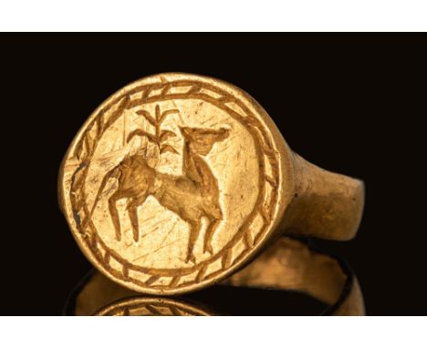 Ca. 400 - 300 BC.A gold signet ring with a flat-section hoop. It has slightly expanding shoulders and a large oval bezel. The