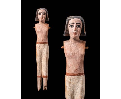 Middle Kingdom, Ca. 2055 - 1790 BC.A carved wooden female figure stands atop an integral platform, featuring close-set legs w