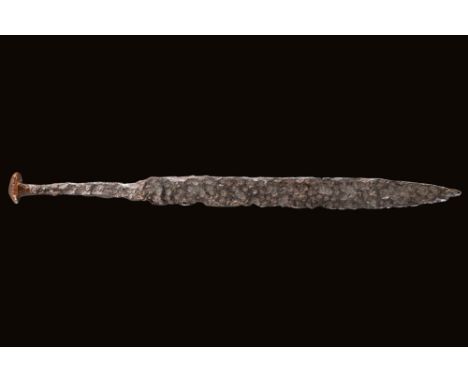 Ca. AD 700 - 1000.A Viking or Norman sword with a long, narrow blade tapering to a sharp point. The hilt is rectangular with 