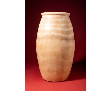 Early Dynastic, Ca. 3100 - 2686 BC.A carved alabaster jar of sturdy form and creamy tan hue with a baluster-shaped body and a