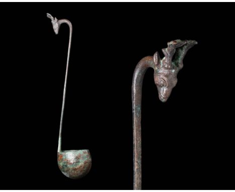 Ca. 500 BC.A rare simpulum (ladle) crafted in bronze, with a deep, round bowl paired with an elongated, flat handle gracefull