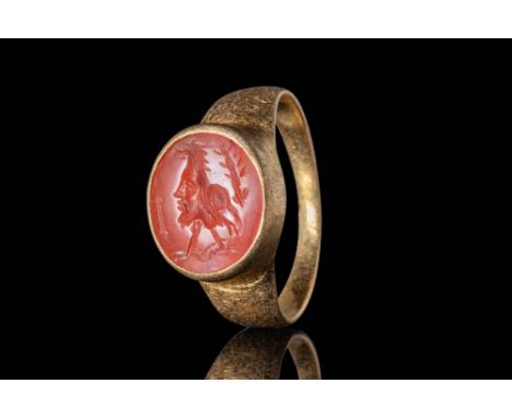 Ca. AD 100 - 300.A stunning gold ring composed of a round hoop set with a carnelian intaglio of "Gryllos". The intaglio showc