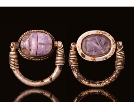 Middle Kingdom, Ca. 2055 - 1790 BC.A silver ring with a tubular section round hoop that tapers towards the finials. The hoop 