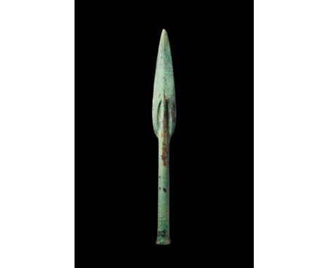 Ca. 1200 - 800 BC.A bronze double-edged spearhead with a leaf-shaped blade, tapering to a sharp point. A longitudinal mid-rib