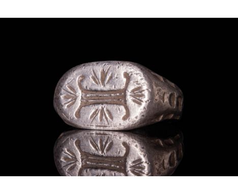 Ca. AD 1200 - 1400 .A silver merchant's seal ring with a flat sectioned round hoop that enlarges on the shoulders to form a b