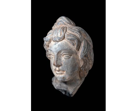 Ca. AD 200 - 300.A finely carved grey schist head of the mother goddess Hariti, with pronounced facial details. The depiction