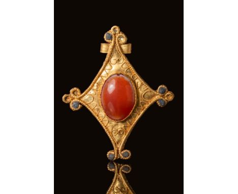 Ca. 300 - 100 BC.A gold brooch displaying intricate filigree work in a symmetrical quatrefoil design. The borders are formed 