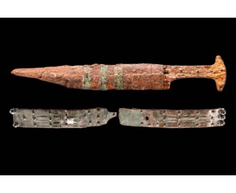 Ca. 600 - 200 BC.A rare forged iron battle dagger with a scabbard adorned with decorative bronze bands. The guard has two pre