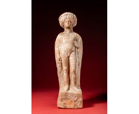 Ca. 400 - 375 BC.A terracotta figure of Dionysus standing atop an integrated plinth. The figure is depicted in a contrapposto