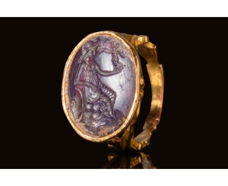 Ca. 100 BC - AD 100. The gemstone is a deep purple amethyst intaglio, engraved with Minerva seated on a pile of rocks. Minerv