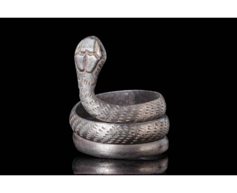 Ca. 30 BC - AD 200.A silver ring fashioned into the form of a coiled serpent, crafted from a single piece of gleaming silver 
