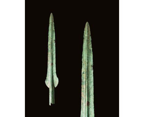 Ca. 1200 - 800 BC.A double-edged spearhead, tapering to a point. A longitudinal mid-rib reinforces the blade, which terminate