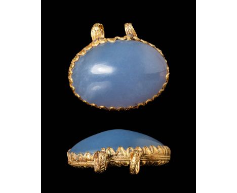 Ca. 300 - 200 BC.A pendant features a high gold frame elegantly adorned along its walls. It houses a mottled blue cabochon ch