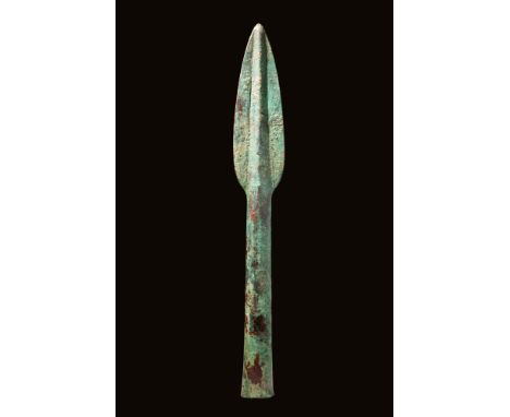 Ca. 1200 - 800 BC.A long bronze spearhead with a leaf-shaped blade that tapers towards the point and with a raised midrib. Th