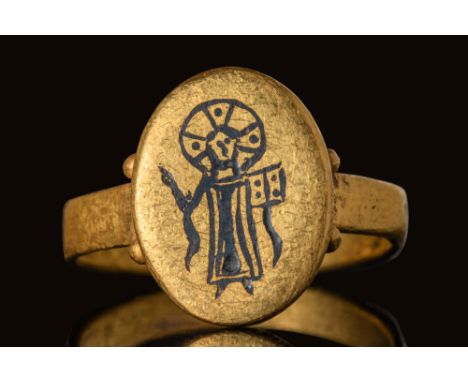 Ca. AD 500 - 700.A gold ring with an octagonal flat-section hoop and an attached oval bezel. The bezel is framed by pairs of 