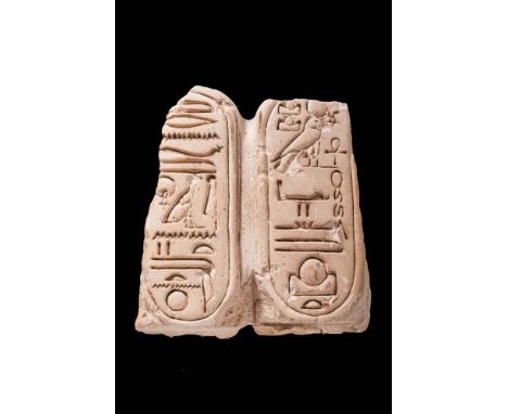 18th Dynasty, Ca. 1353 - 1336 BC.A block of crystalline marble shaped as a double cartouche, enclosing inscriptions of the su