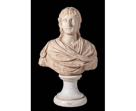 Ca. AD 100 - 200.A marble bust of a noblewoman. The subject bears a solemn expression, gazing to her right, with wavy locks f