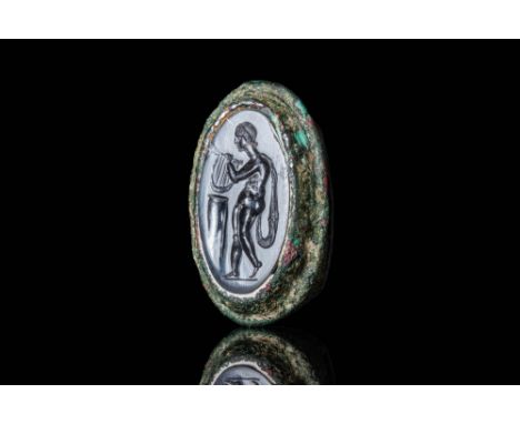 Ca. 100 BC .A Stunning bronze ring with a D-section hoop that enlarges at the shoulders to form an oval bezel, securing an ag