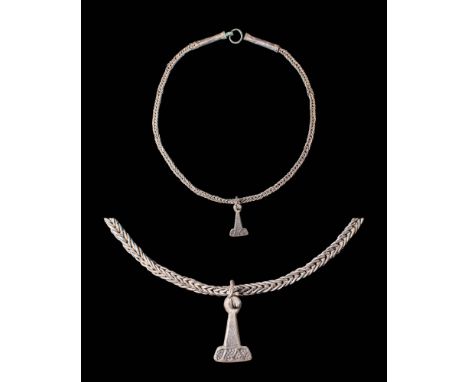 Ca. AD 900 - 1000.A silver necklace features very narrow links arranged in a wide choker that connects at the back with two t
