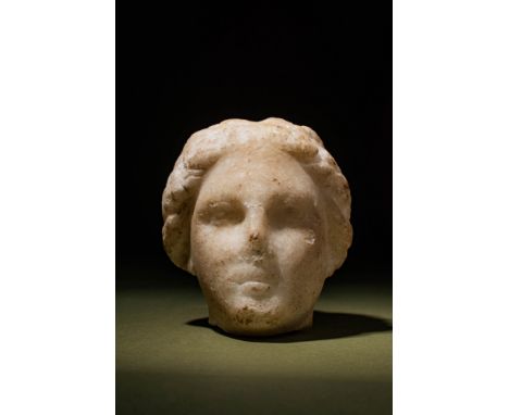 Ca. AD 200 - 300.A finely carved white marble head of a youth with an expressive countenance. While it may not be imperial, i
