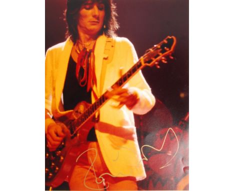The Rolling Stones - Ronnie Wood - incredible large hand signed photograph of Wood on stage, with guitar. Signed in gold mark