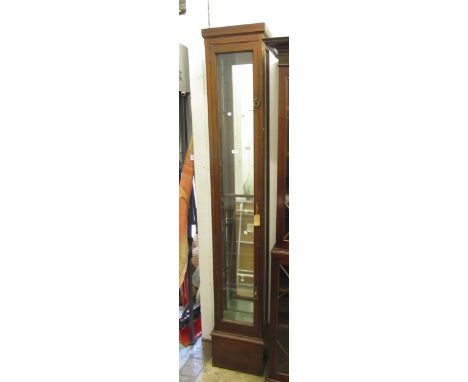Early 20th Century tall and narrow mahogany shop display cabinet with a single door enclosing glass shelves, 220 x 39cm20cm d