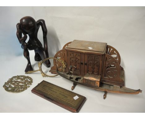 Brass mounted wooden cribbage board, wooden fretwork cabinet, carved wooden sculpture and sundries