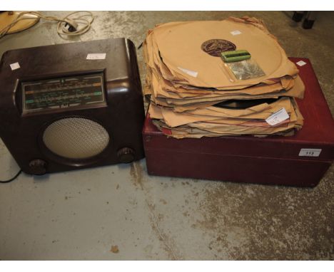 Table top wind-up gramophone in simulated red leather case, together with a quantity of various 78s and a brown Bakelite radi