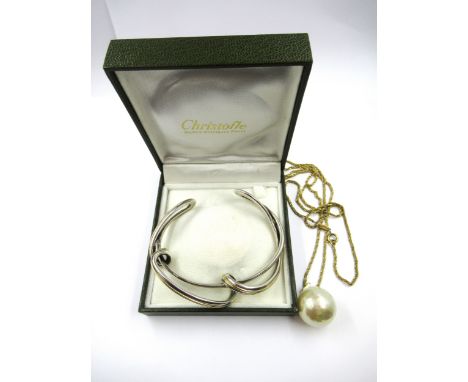 Christofle silver bangle of stylised crossover form, together with a Christian Dior chain and pendant