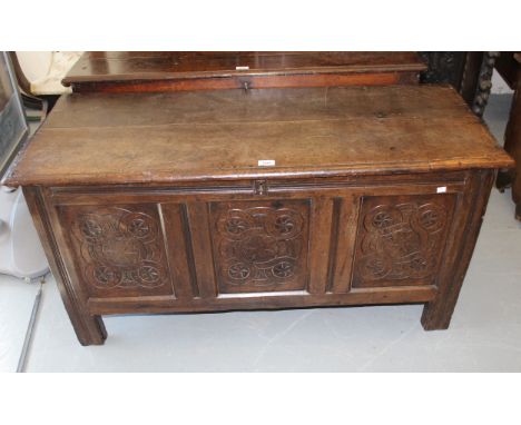 17th Century oak coffer, the hinged moulded plank top above a carved three panel front on stile supports, 122cm wideOverall i