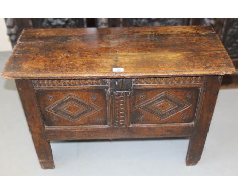 Small 17th Century oak coffer, the hinged cover above a two panel front on stile supports, 85 x 36 x 59cm