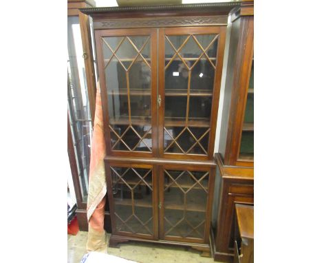 Edwardian mahogany bookcase, the moulded cornice with blind fretwork detail above a pair of bar glazed doors enclosing shelve