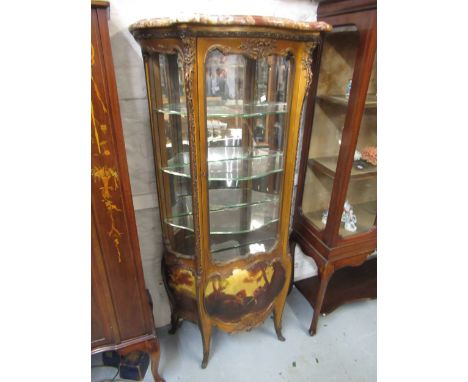 19th Century giltwood and ormolu mounted vitrine, the rouge marble top above a serpentine shaped glazed door and bombe shaped