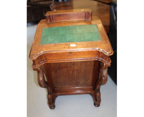 Victorian oak Davenport, the superstructure top with hinged cover enclosing a fitted interior and writing slope enclosing nin
