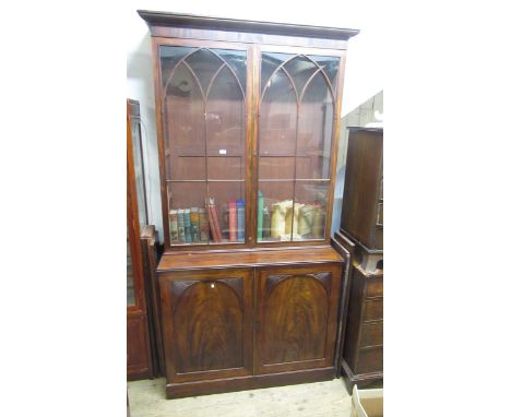 George III mahogany bookcase / linen press, the moulded cornice above two astragal glazed doors, the base with two panel door