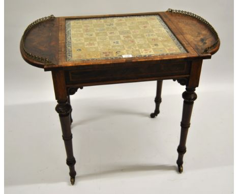 Victorian rosewood and kingwood banded games table, the rounded galleried ends enclosing a hinging glazed centre panel with a